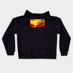 Apocalyptic scenery with a bath of violent clouds in the sunset sky full of raging red and yellow colours Kids Hoodie